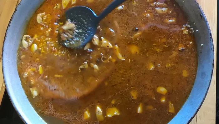 Añadir azafrán y gambas: Agregar el azafrán y las colas de gamba cortadas (a los 3-4 minutos de cocción). Cocinar a fuego fuerte durante 5 minutos.