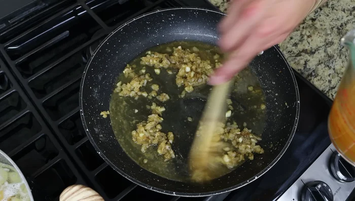 Agregar gradualmente el caldo de verduras, mezclando continuamente hasta obtener una salsa cremosa. Agregar las albóndigas a la salsa, asegurándose de que estén cubiertas uniformemente. Cocinar a fuego medio-bajo hasta que estén calientes.