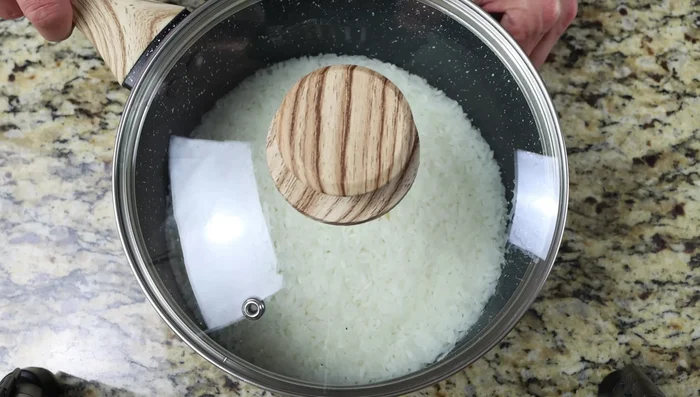 Desmenuzar el arroz con un tenedor y dejar enfriar ligeramente (5-10 minutos).