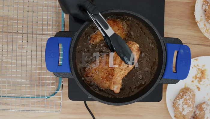 Colocar el pollo frito en una rejilla (opcional) para escurrir el exceso de grasa.