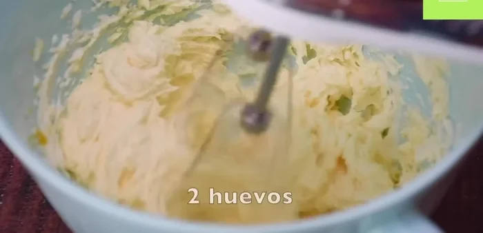 Agrega los huevos (a temperatura ambiente), la crema ácida, la vainilla y la leche. Mezcla bien.