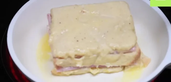 Freír el sándwich hasta que esté dorado por ambos lados, añadiendo mantequilla según sea necesario.