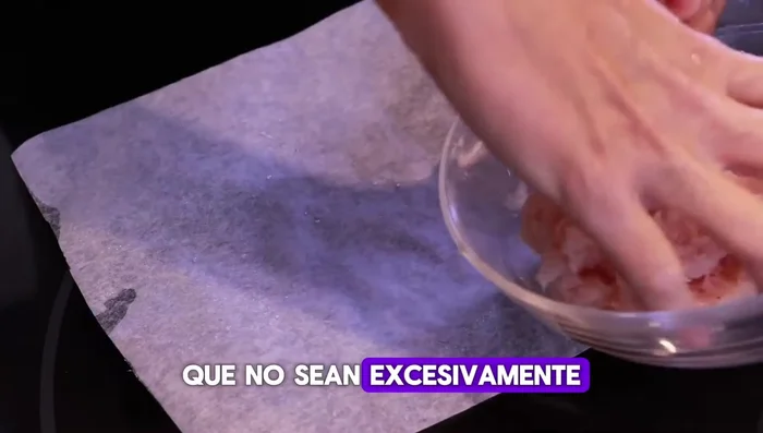 Extender pequeñas porciones de la mezcla de pollo sobre papeles de horno pequeños, formando círculos finos. Humedecer las manos para evitar que se pegue.