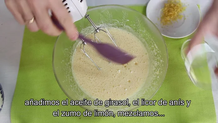 Añade el aceite de girasol, el licor de anís, el zumo de limón y la ralladura de limón. Mezcla.