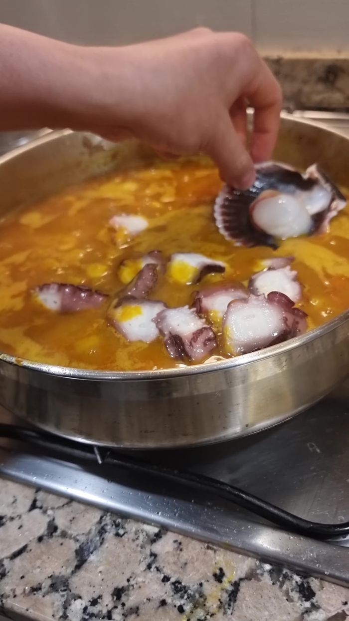 Retirar la hierbabuena. Agregar pulpo cocido, zamburiñas, langostinos marcados y arvejas (si no están precocidas). Tapar por 3 minutos (183.2).