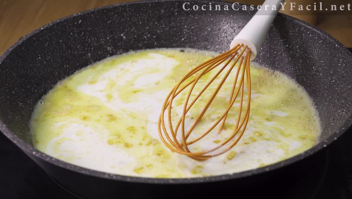Agregar la leche en dos tandas (primero 200-250 ml), mezclando constantemente con la varilla hasta obtener una salsa espesa (140.36).