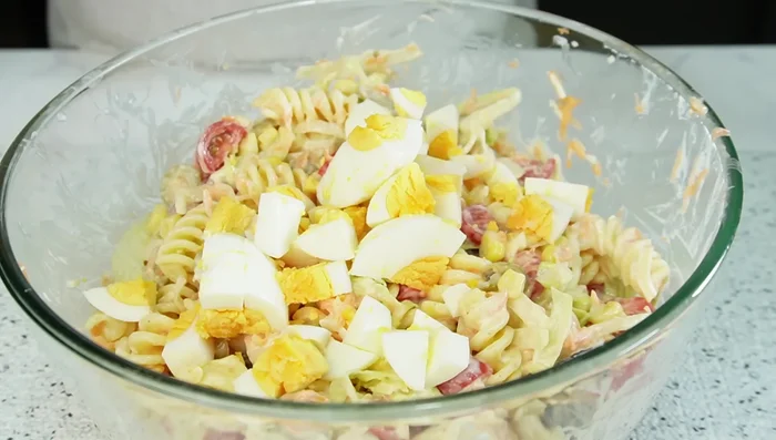 Agregar los huevos cocidos picados en cubos. Mezclar nuevamente. [365.88]