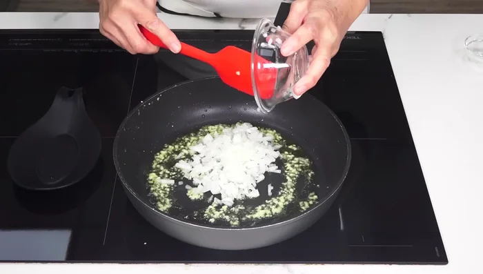 Añadir la cebolla a la sartén con una pizca de sal y cocinar durante 7 minutos.
