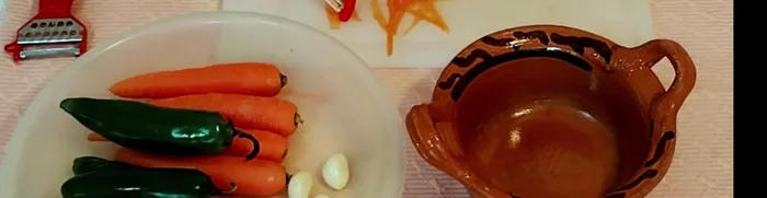 Preparar la vinagreta: Calentar el aceite en una sartén. Agregar los ajos, las cebollas, los chiles, las zanahorias, las hierbas (laurel, mejorana, tomillo), el orégano, los clavos, las pimientas, el consomé (opcional) y dos tazas de agua. Sazonar con sal al gusto.