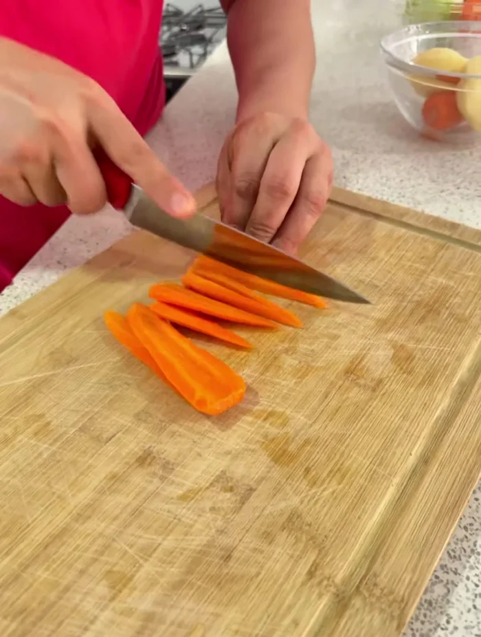 Lavar las papas, zanahorias y cebolla. Cortar las zanahorias en rebanadas finas y luego en trozos pequeños. Cortar las papas en trozos más grandes, para que se noten en la sopa.
