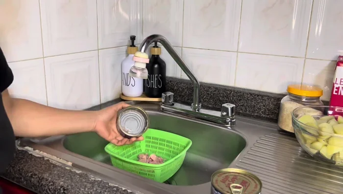 Escurrir el agua del atún.