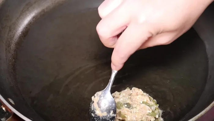 Calienta aceite en una sartén a fuego medio. Forma pequeñas tortitas con la mezcla y aplástalas ligeramente.