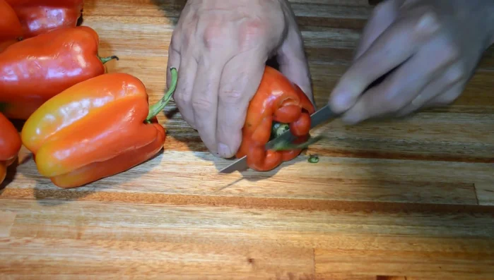 Cortar los pimientos por el borde para que queden planos. Retirar los corazones y enjuagar. (118.399)