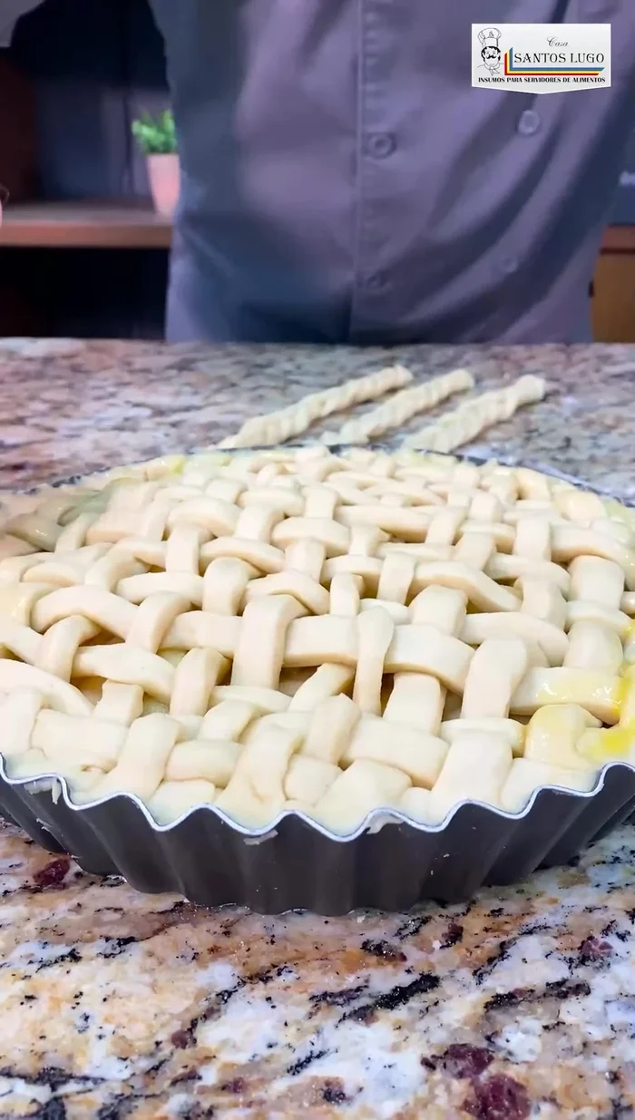 Barnizar la tarta con huevo batido (opcional). Se pueden agregar trenzas de masa en los bordes.