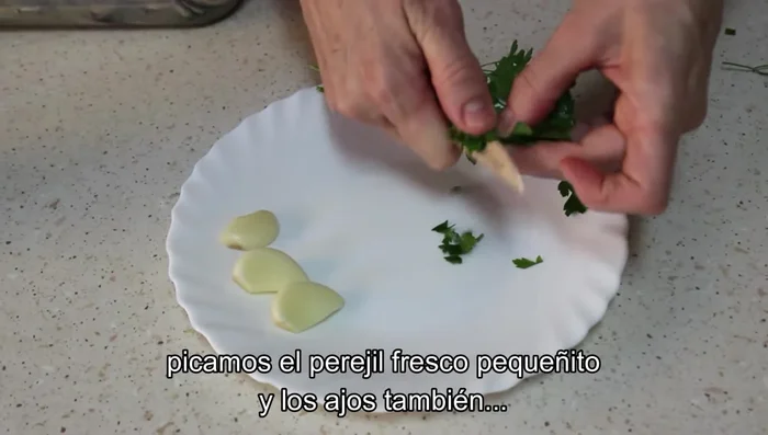 Picar finamente el perejil y los ajos.
