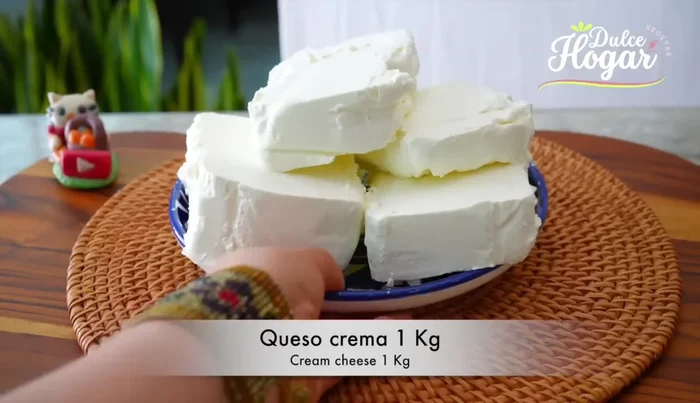 Preparar el relleno: Batir el queso crema hasta obtener una consistencia cremosa. Agregar el azúcar y continuar batiendo.
