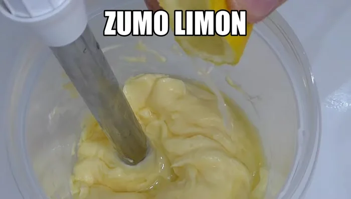 A la mayonesa, añadir un chorrito de limón, dos cucharadas de postre de mostaza antigua y un yogur griego. Mezclar bien.