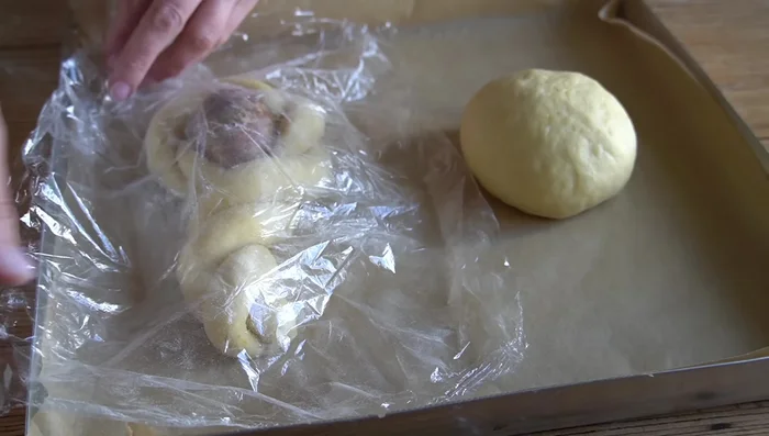 Colocar la mona en una bandeja forrada con papel de hornear, tapar con film transparente y dejar que suba casi el doble de su tamaño (aproximadamente 2 horas y media a 20°C).