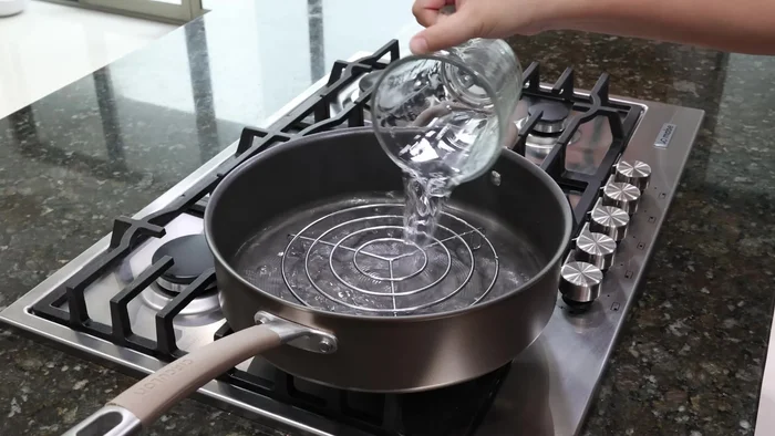 Colocar el molde sobre una vaporera en una olla con agua hirviendo. Tapar y cocinar a fuego medio durante una hora. (127.36)