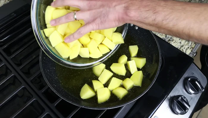 Agregar las patatas a la sartén (127.36), mezclando ligeramente para cubrirlas con el aceite. Freírlas durante 25-30 minutos, revolviendo cada 3-4 minutos para que se frían uniformemente (133.92).