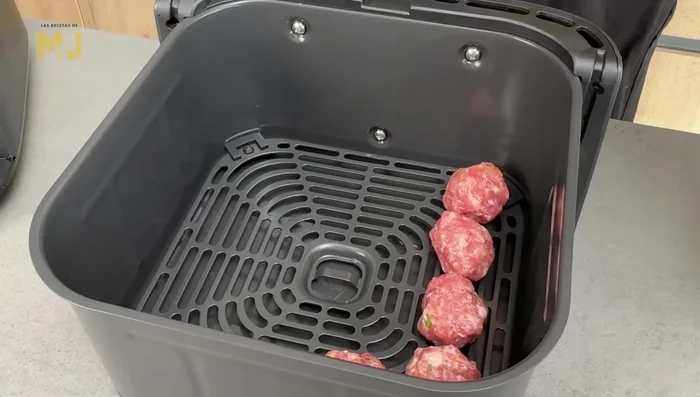 Colocar las albóndigas en el cajón inferior y las patatas en la rejilla.