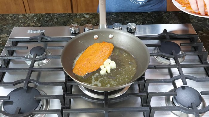 En una sartén, agregar suficiente aceite. Agregar 4-5 dientes de ajo y 1/4 de cebolla picada. Agregar 3 chiles guajillo (sin venas ni semillas) y 3 chiles de árbol. Mezclar hasta que esté dorado.