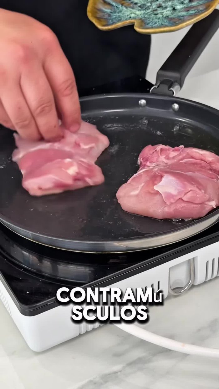 En otra sartén, saltear los contramuslos de pollo con la piel hacia abajo, haciendo presión y tapando con un plato a fuego bajo.