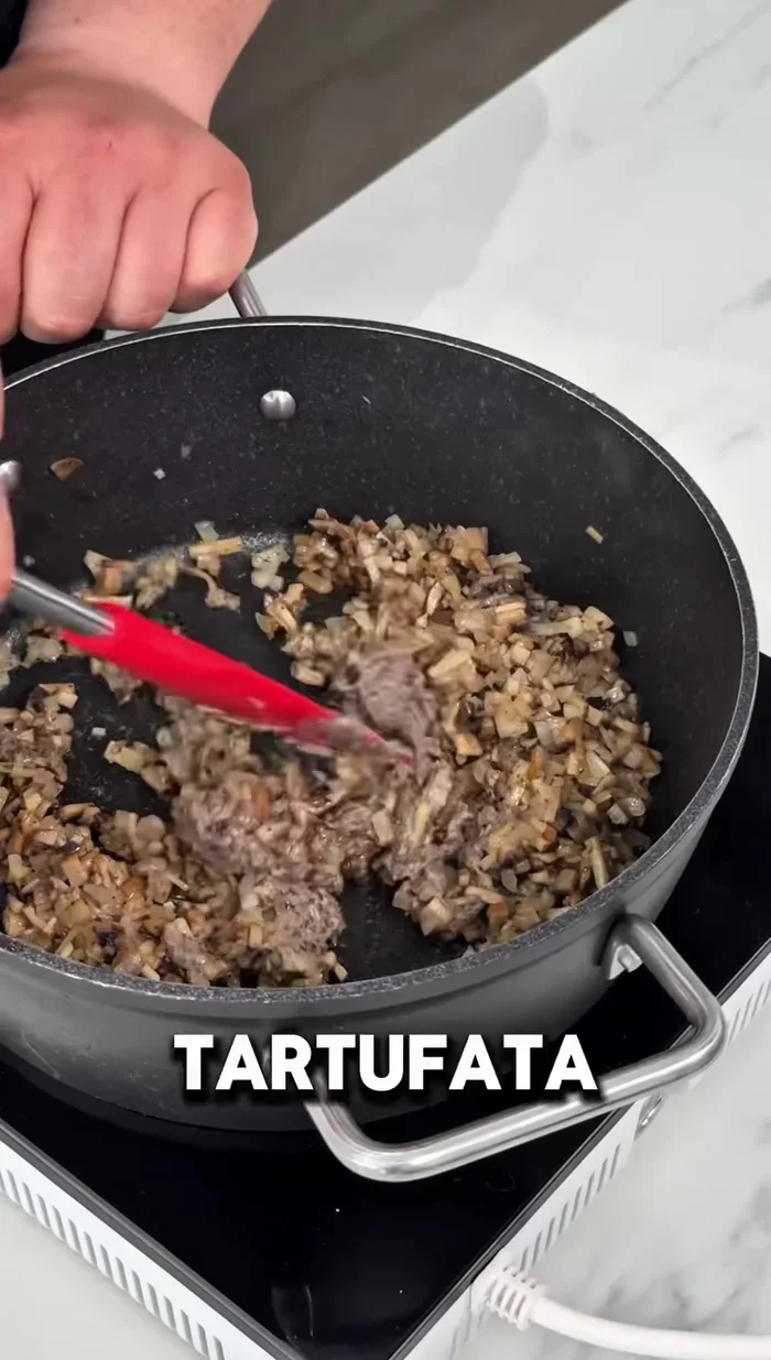 Añadir dos cucharadas de tartufata a la sartén con las setas.