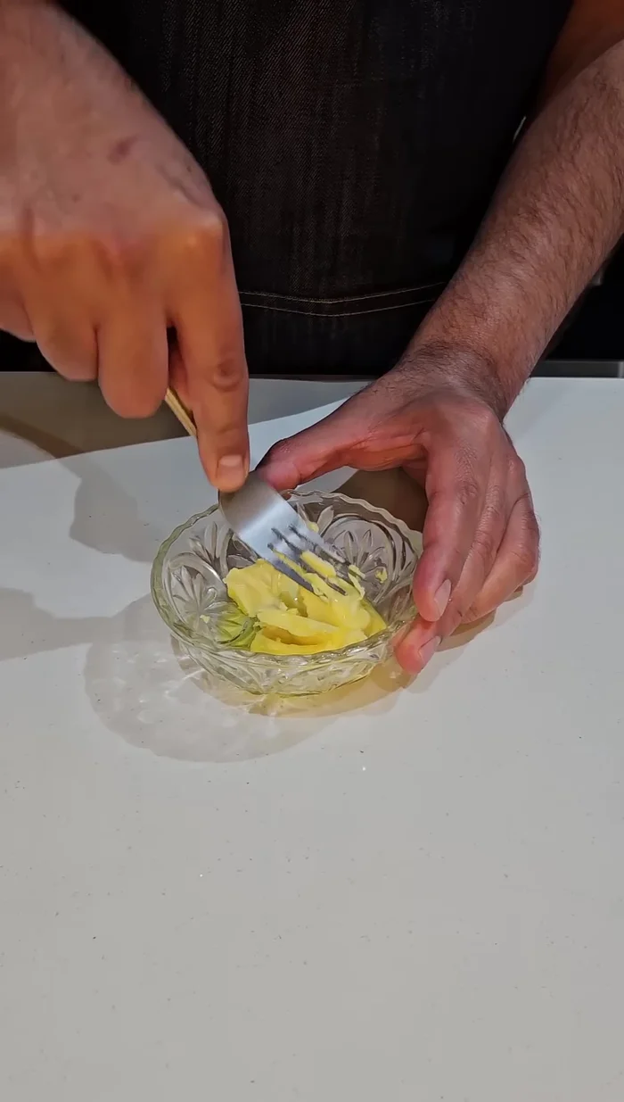 Untar la mezcla de mantequilla y aceite en las rebanadas de pan.