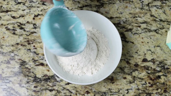 Mientras tanto, preparar los ingredientes secos: mezclar la harina para todo uso y el ajo en polvo en un tazón.