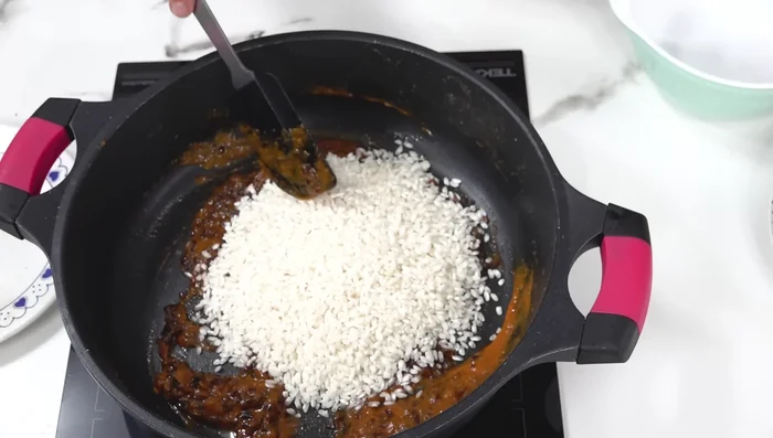 Agregar el arroz y sofreír ligeramente.
