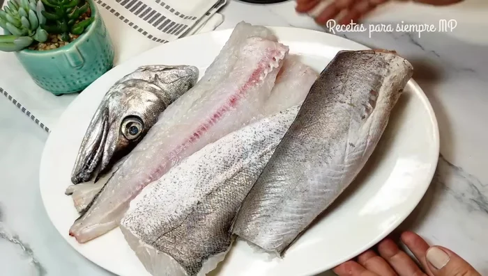 Tostar pan. Preparar la merluza (cabeza, espina, filetes). Puedes usar otros pescados como jureles o rape.