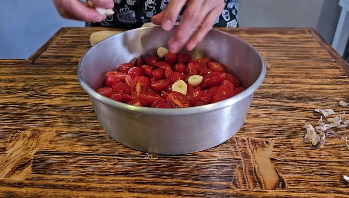 Colocar los tomates cherry y el ajo en un recipiente.