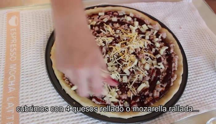 Cubrir con más mozzarella o cuatro quesos rallados. (103.719)