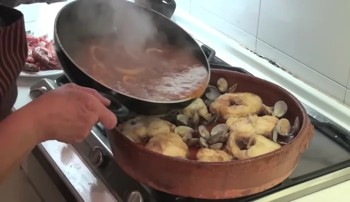 Incorporar la salsa con los calamares a la cazuela de barro. Distribuir bien.