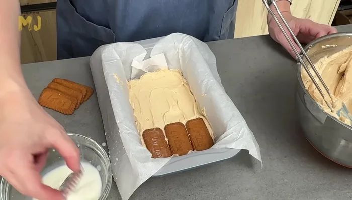 Repetir las capas de galletas mojadas en leche y crema (al menos 2 capas más de cada una).